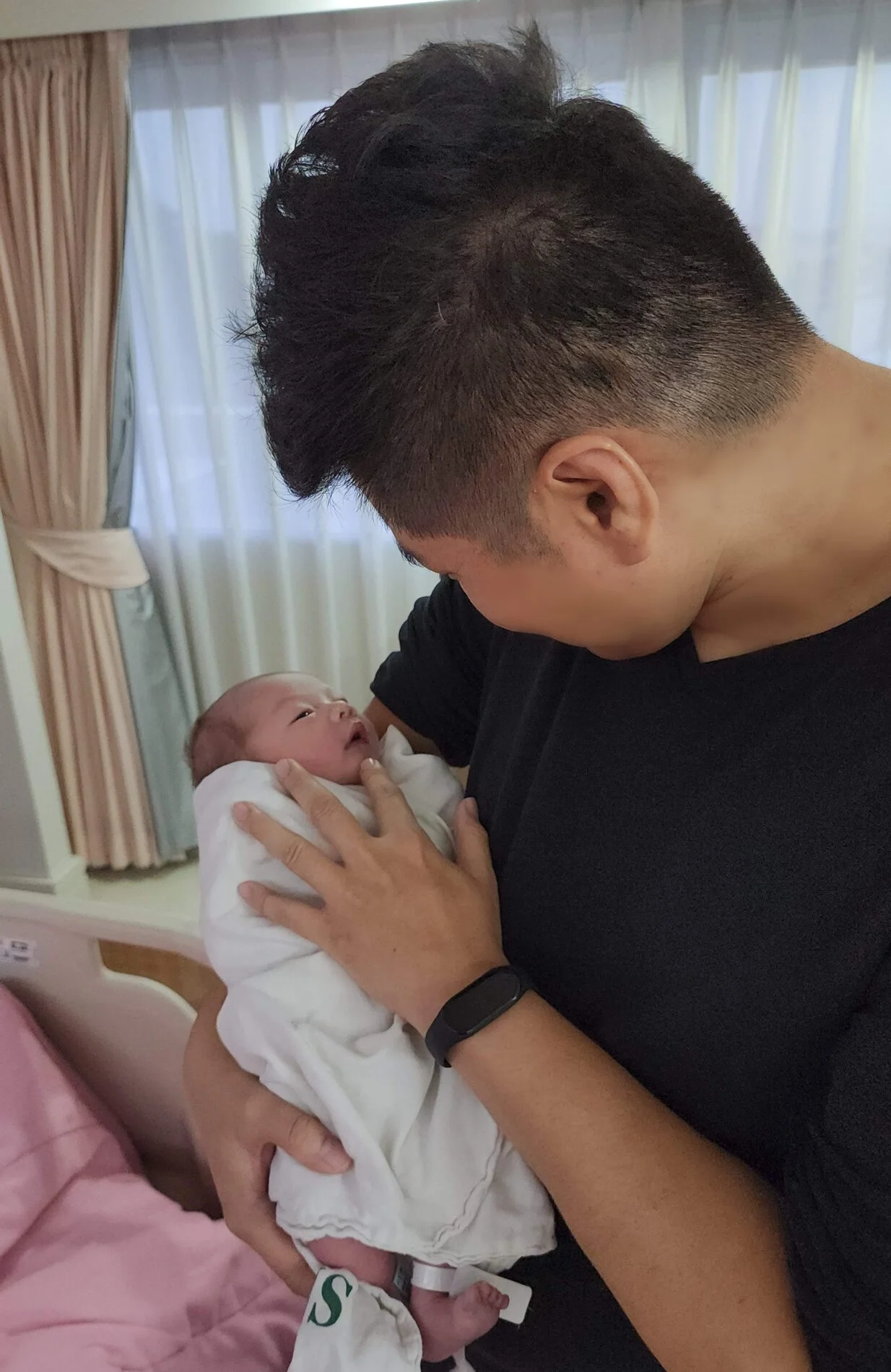 Xavier holding his newborn son for the first time
